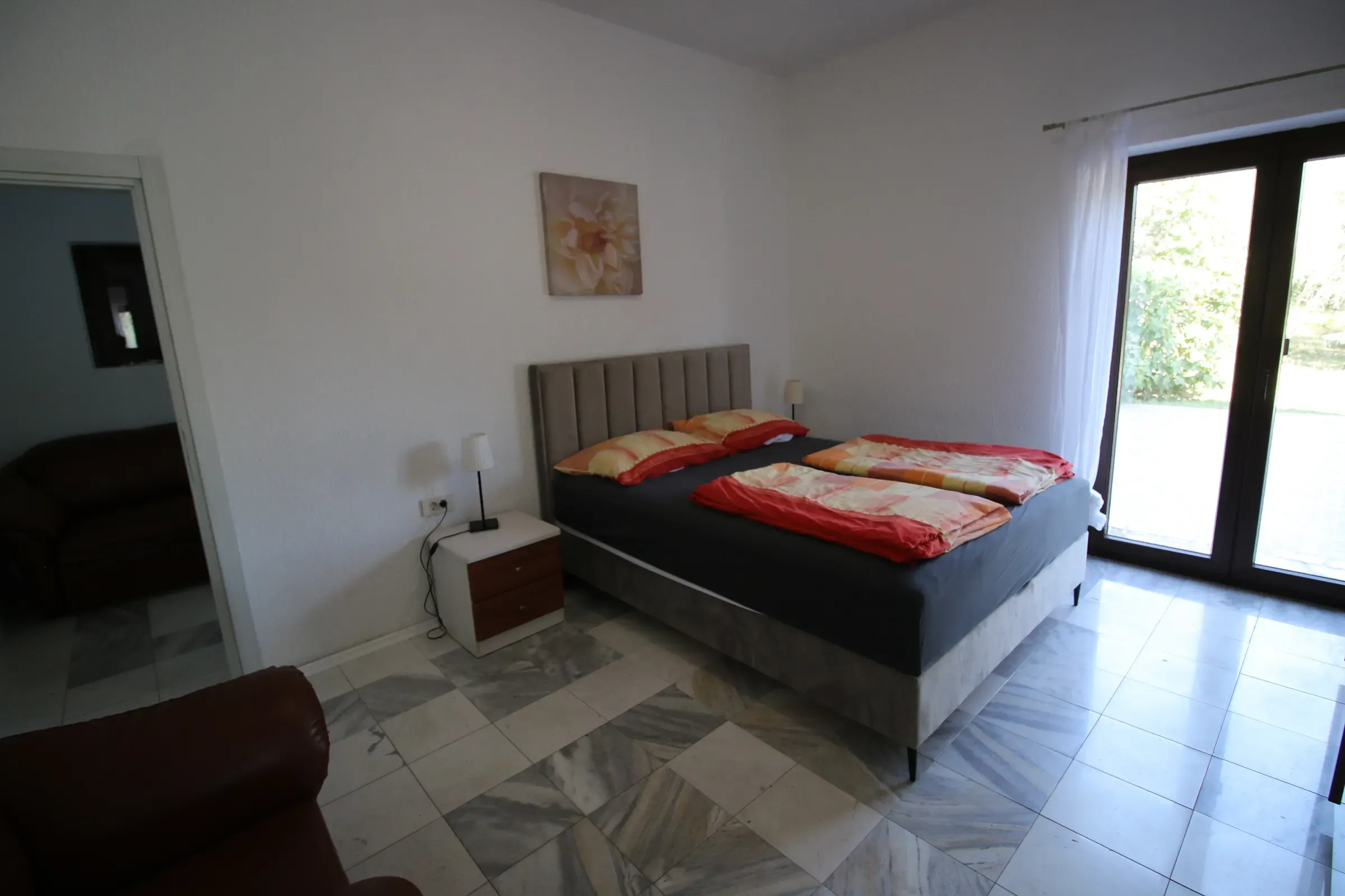 Bedroom with an extra seating corner and garden light