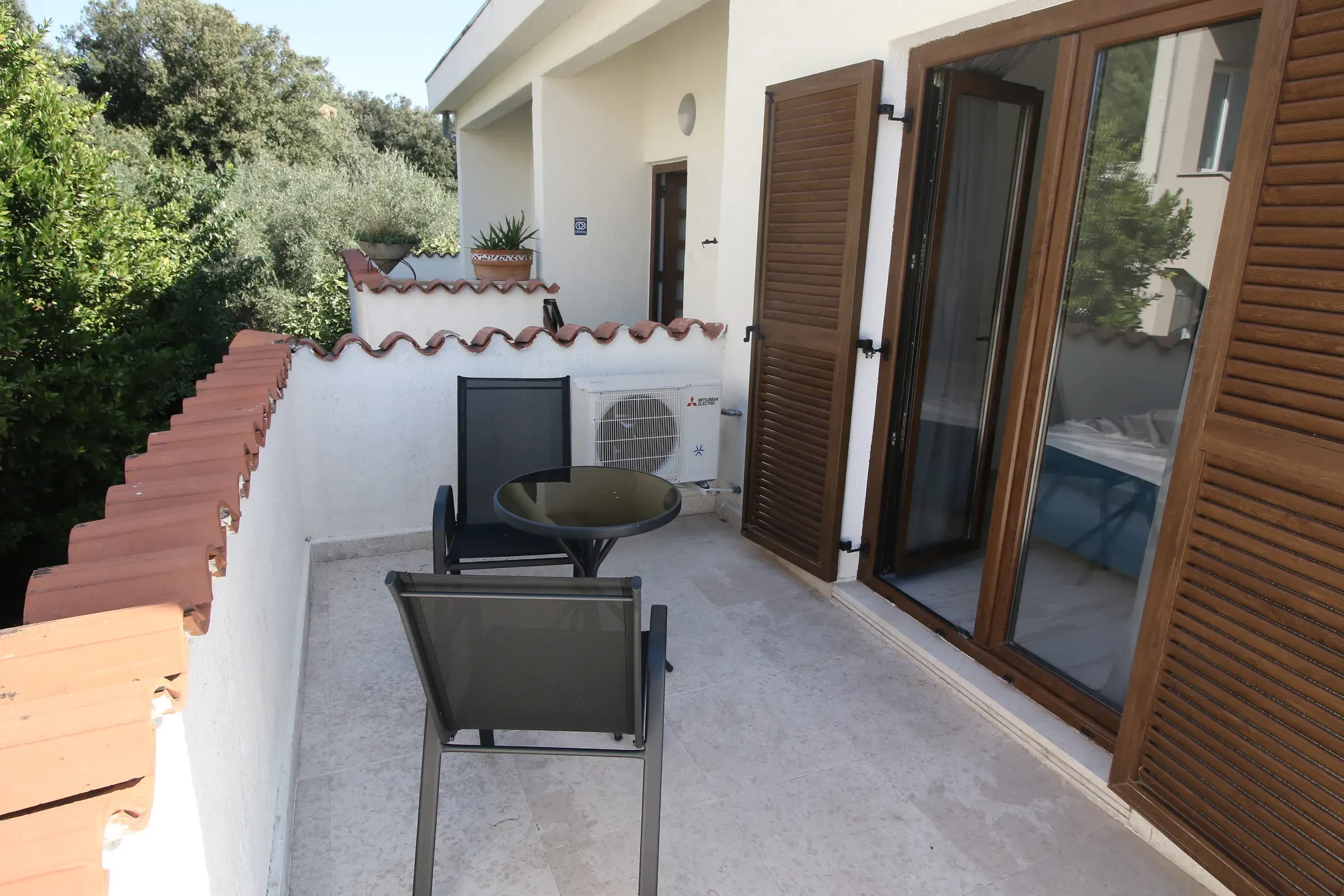 Private upper terrace with seating and wooden shutters