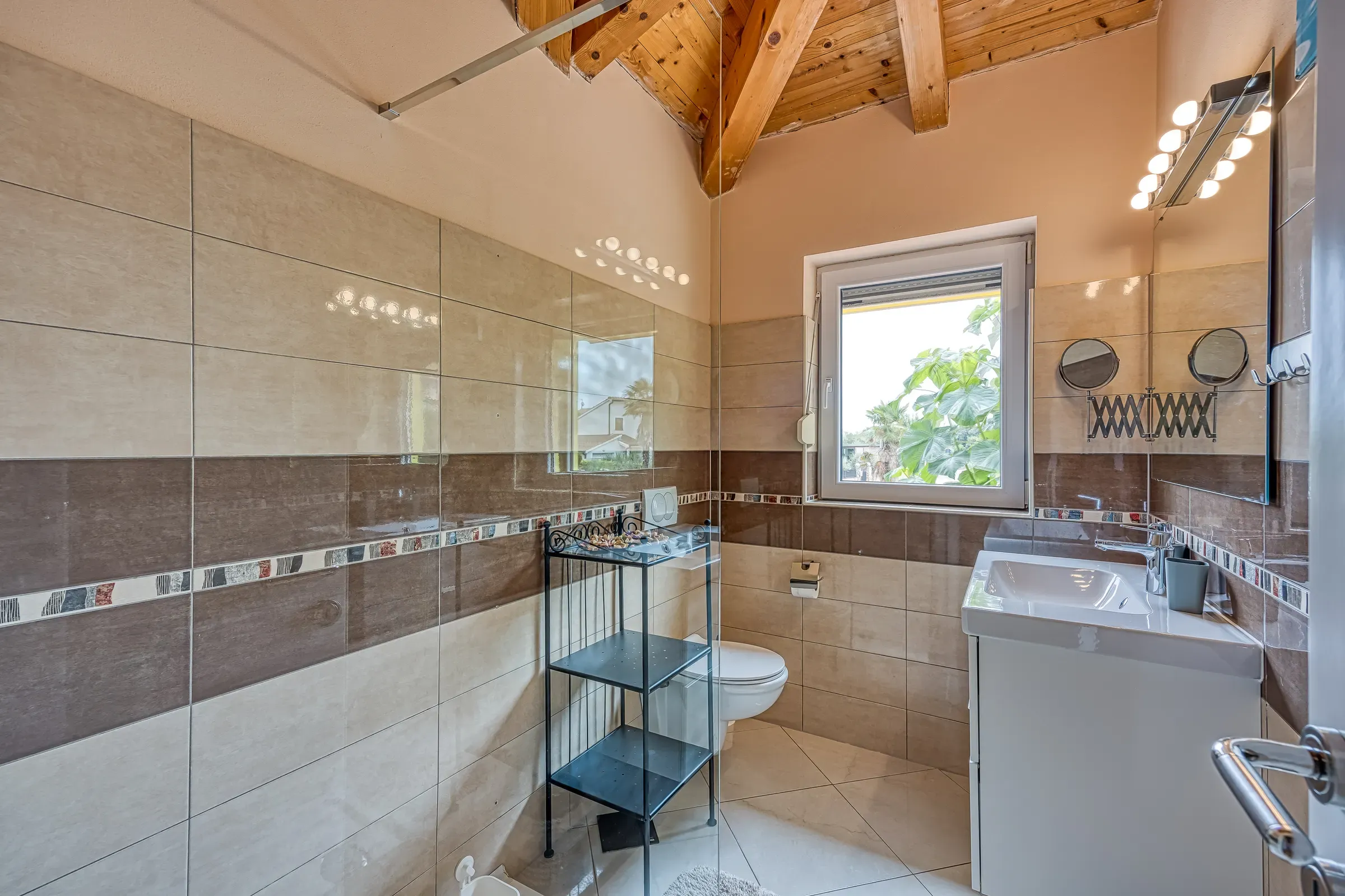 Warm-tiled bathroom with a glass walk-in shower
