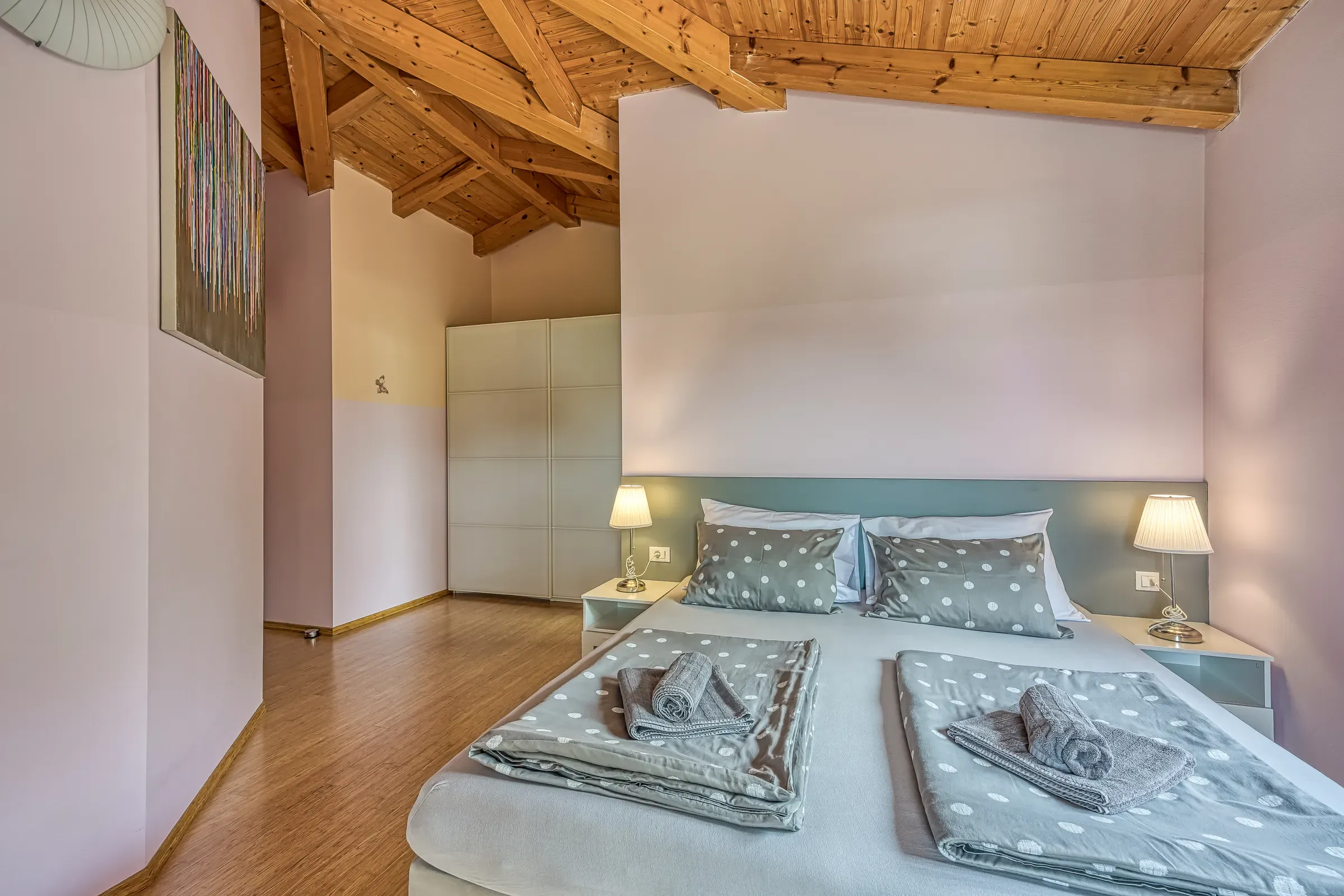 Calm double bedroom beneath the vaulted wooden ceiling