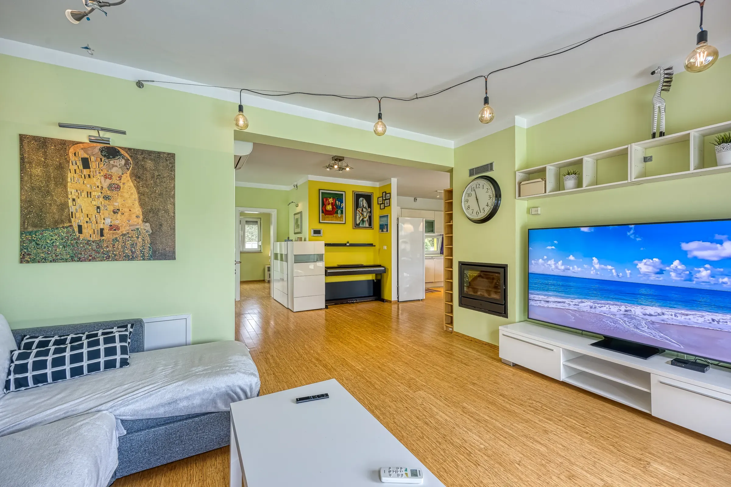 Open-plan living room with a large TV wall and fireplace