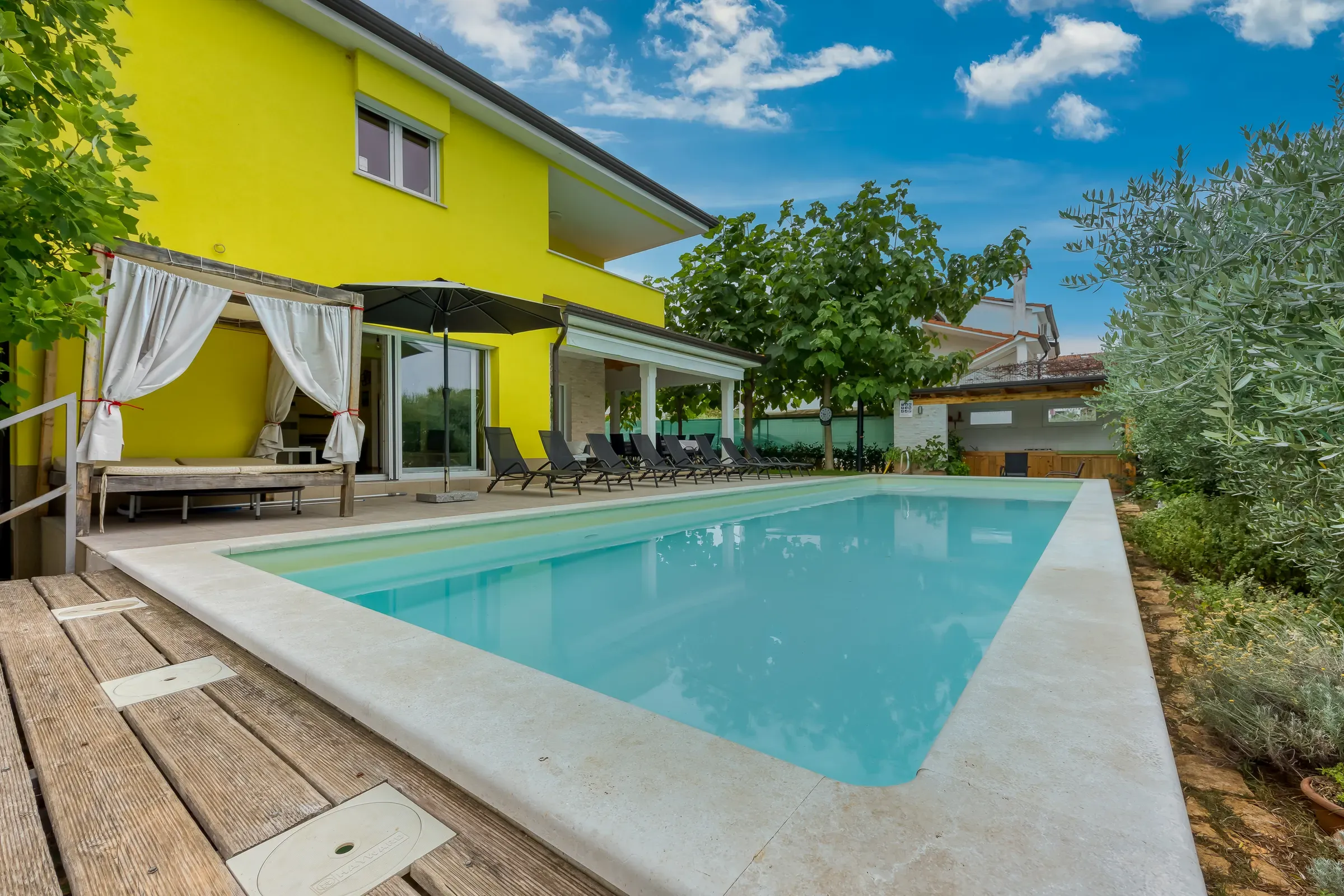 Canopy daybed beside the XL pool of Villa Gaya