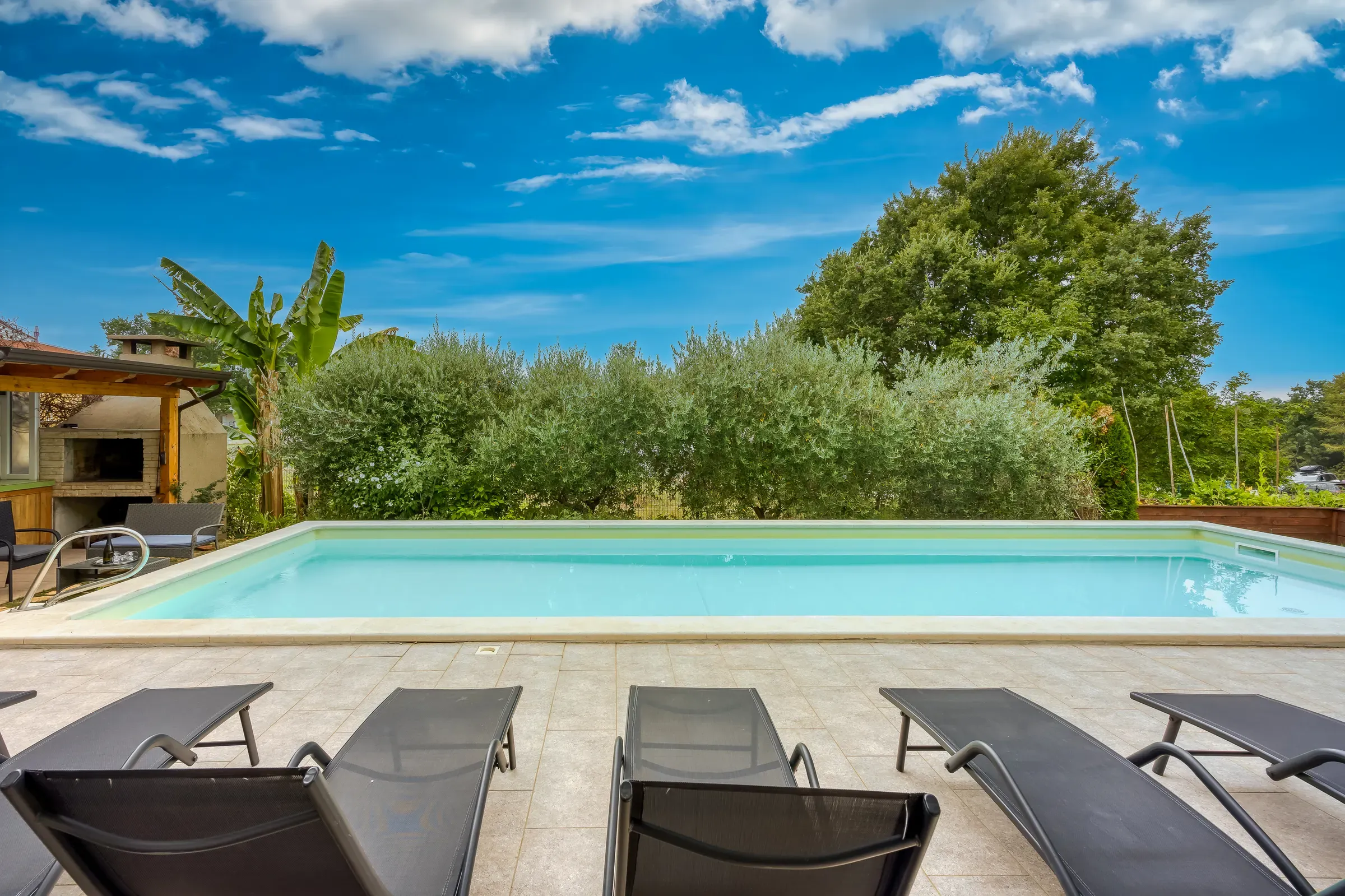 The XL pool of Villa Gaya stretching through the Mediterranean garden